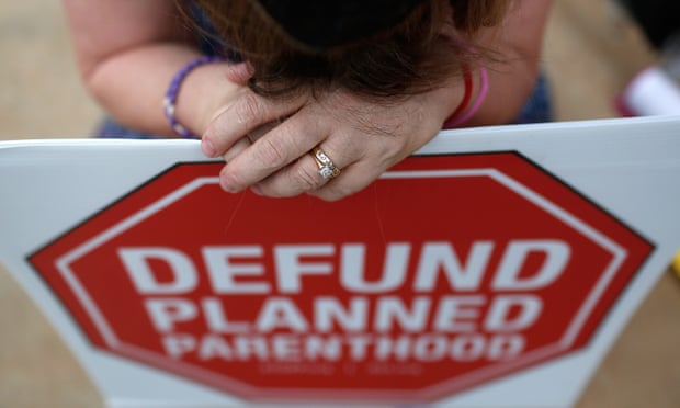 A Right to Life protester prays during a sit-in in front of a proposed Planned Parenthood location.