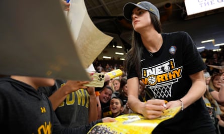 Caitlin Clark signs autographs during an Iowa team celebration