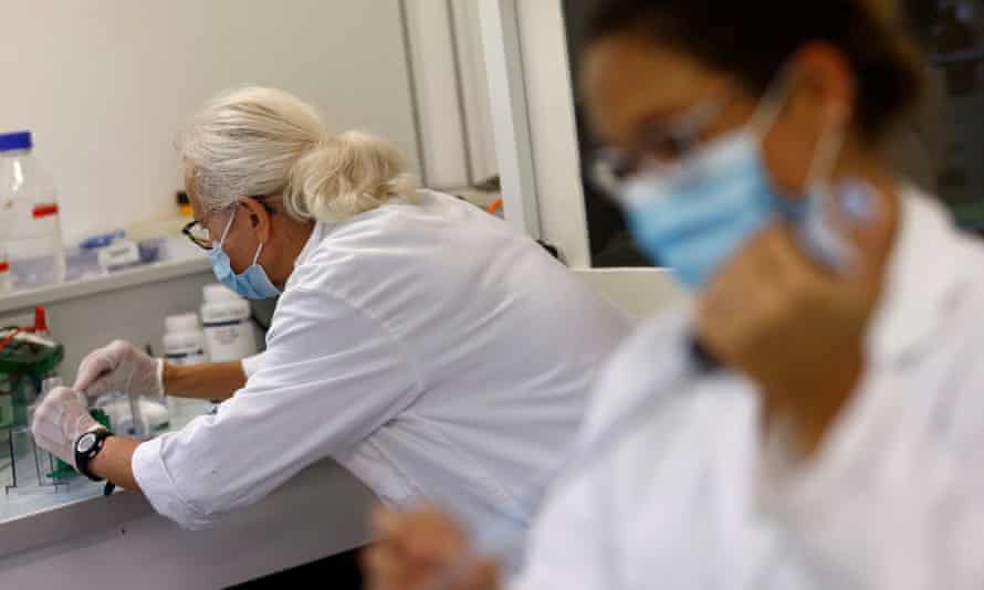 masked researchers in lab