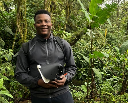 Dara Ojo among dense foliage with his camera