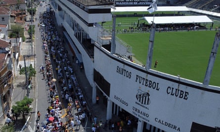Fans queue outside the Urbano Caldeira stadium in Santos to attend Pelé’s wake.