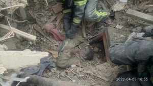 Rescuers remove the woman from debris after a military strike in the town of Rubizhne, in Luhansk region