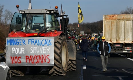 A tractor blocks the A20 highway near Argenton-sur-Creuse in France with a sign reading ‘Eat French products to save your farmers’