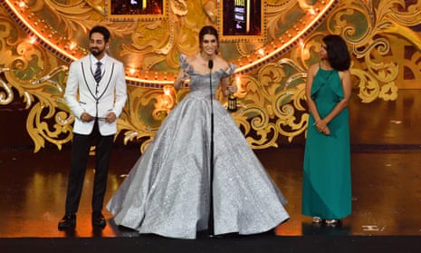 Kriti Sanon receives an award from Ayushmann Khurrana, left, and Deepika K, right, at last year’s IIFA in Bangkok.