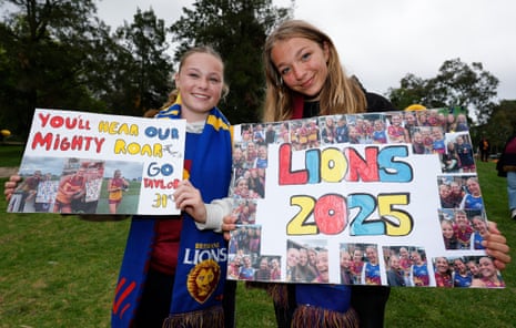 Lions fans pose with signs ahead of the 2025 AFLW grand final