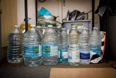 Bottles of water of different sizes on the floor of a property