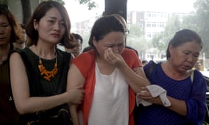 Fan Lili, center, the wife of activist Gou Hongguo, is escorted by Li Wenzu, left, the wife of imprisoned lawyer Wang Quanzhang outside the Tianjin No. 2 Intermediate People’s Court in Tianjin, China.