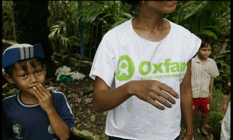 An Oxfam aid worker with children in Indonesia.