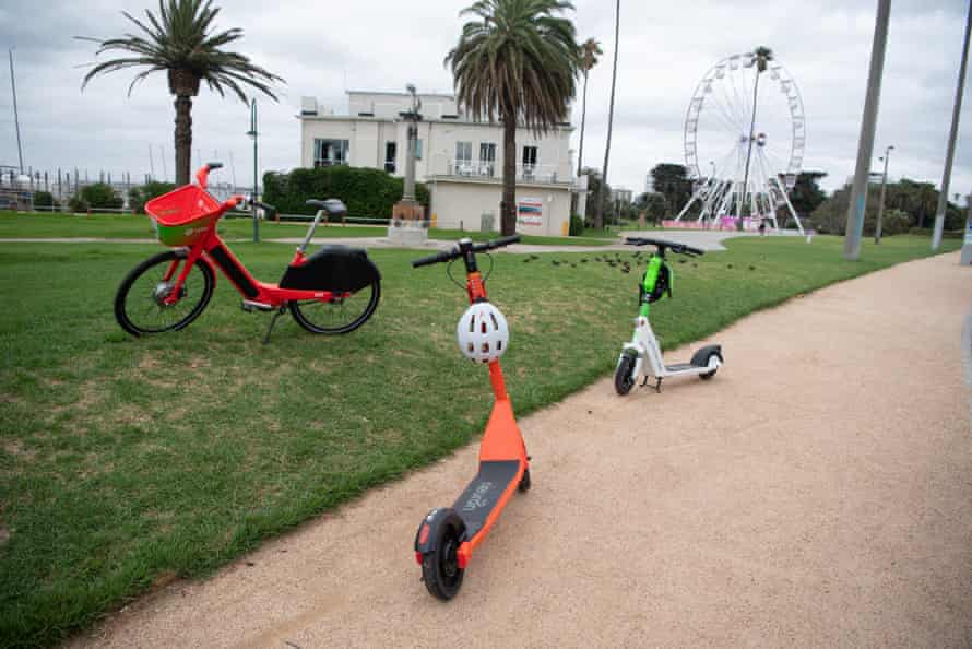 Lime and Nueron e-scooters and a Jump bike are parked at St Kilda, Melbourne Australia.