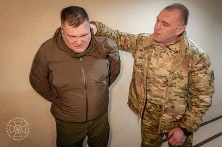 Vasily Malyuk holding Dmitry Kozyura by his jacket collar