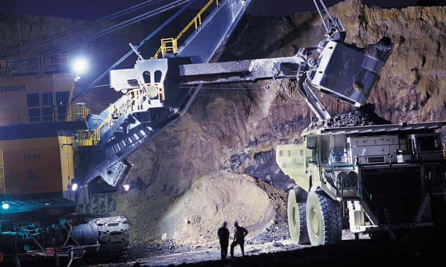 Heavy machinery operates in a coal mine