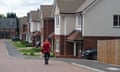 a postman delivers mail at a new-build housing estate