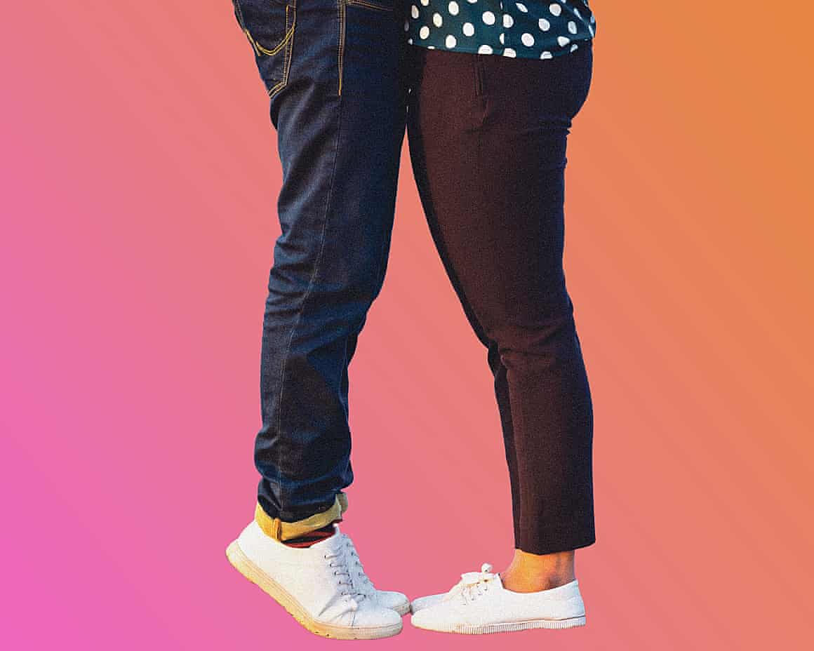 The lower half of two people standing face to face. One is standing on tiptoes.