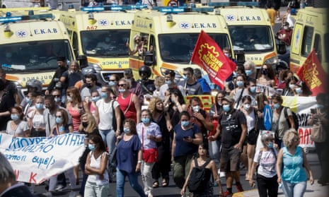 Hundreds of Greek healthcare workers, accompanied by ambulances, protest in the centre of Athens.