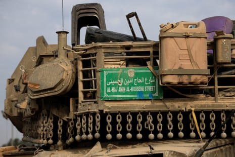A street sign taken from Gaza is seen on a tank near the Israel-Gaza border, in southern Israel
