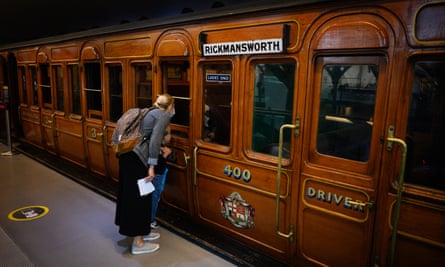 Visitors explore a train exhibit at the London Transport museum