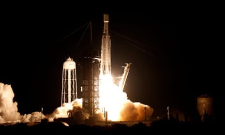A nighttime image of a rocket brightly blasting skyward.