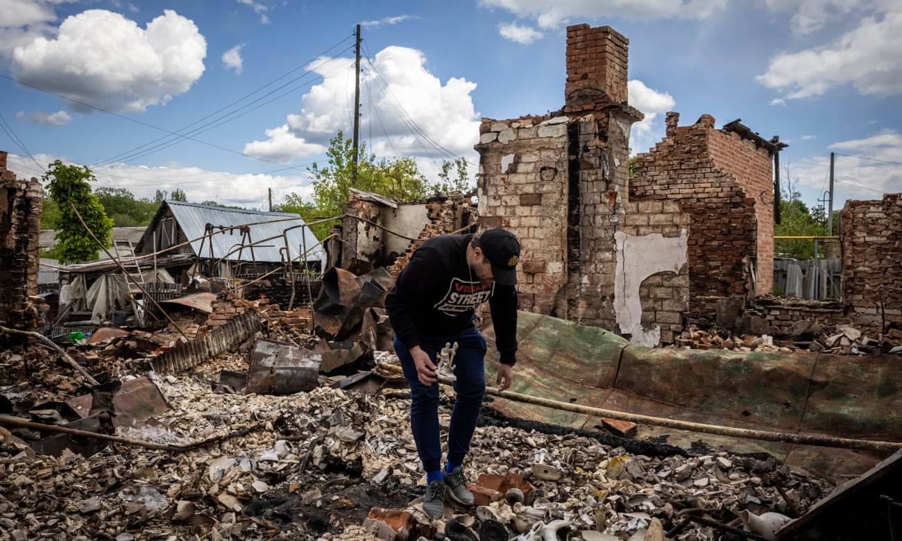 Kostantin Polovinkina salvages porceline statues fron his destroyed home in Kutuzivka.
