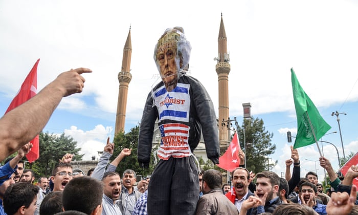 Protesters hold an effigy of US president Donald Trump as they shout slogans in front of the Israel consulate in Diyarbakir, Turkey
