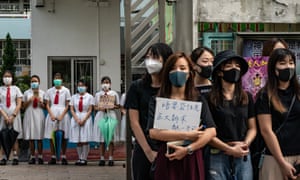 Students form a human chain during a protest on Thursday in Hong Kong. Carrie Lam has backed police to handle the protests despite claims of brutality.