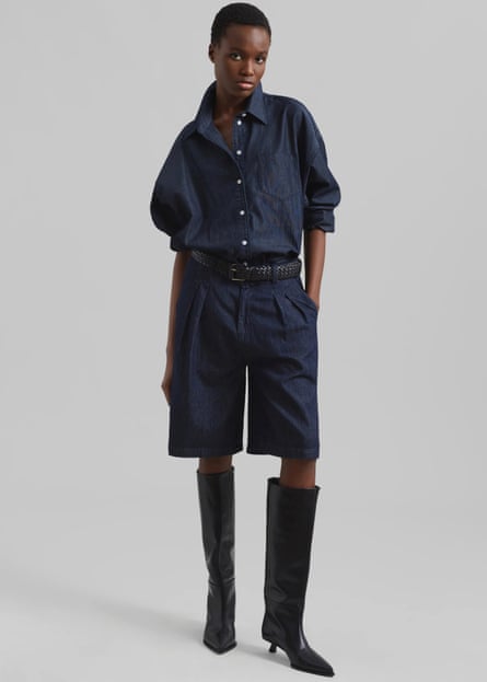 Model wearing dark denim Bermuda shorts and matching shirt