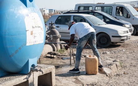 A migrant worker washes his hands.