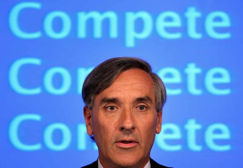 John Redwood, being banner saying 'compete compete copmete'