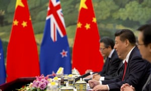 Chinese and new zealand flags at a Xi meeting