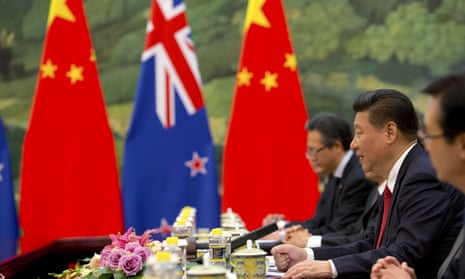 Chinese and new zealand flags at a Xi meeting