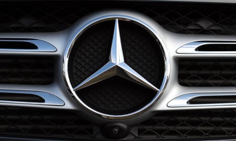 a Mercedes car badge on the front grill of a car