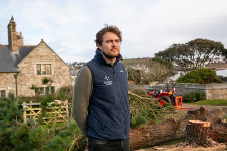 Henry Mathews of St Aubyn Estates stands before a tree lost to Storm Goretti