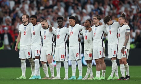England players stand on the halfway line during the penalty shootout against Italy.