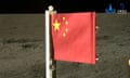 A Chinese flag – red, with one large yellow star and four smaller ones in the top left-hand corner – is seen against the dark, rocky lunar surface.
