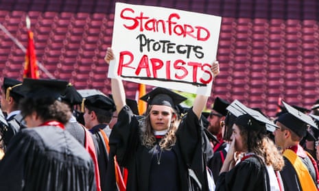 A woman carries a sign in solidarity for a Stanford rape victim during graduation at Stanford University, in Palo Alto, California.