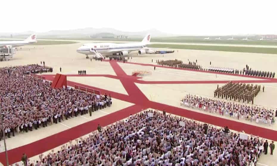 A plane with the Chinese president, Xi Jinping, onboard arrives at Pyongyang’s airport. Reports said 10,000 people welcomed Xi alongside Kim Jong-un.