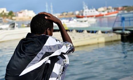 A survivor of the shipwreck of immigrants off the Italian coast looks out over the water of Lampedusa.