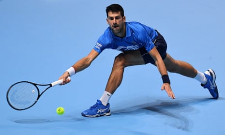 Novak Djokovic stretches to play a forehand.