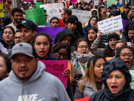 crowd of people holding signs