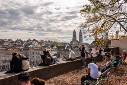 Young people looking over the River Limmat near Lindenhof in Zurich