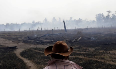 A farmer next to a smouldering field after it was hit by a fire in Rio Pardo, Rondonia, Brazil 16 September 2019.