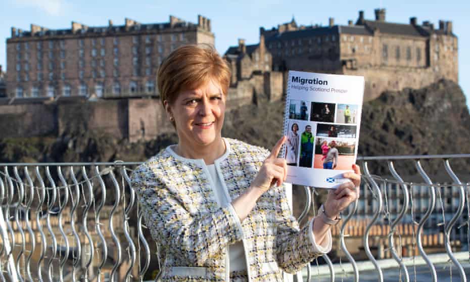 Nicola Sturgeon holds the policy paper on migration at its launch in Edinburgh