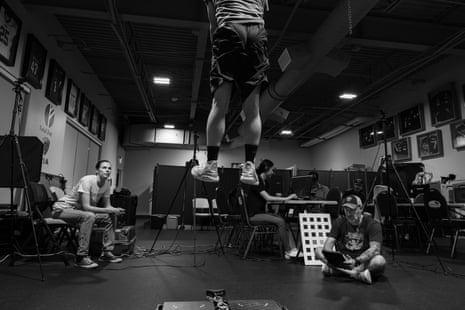 A man jumping arsenic 2 coaches look on