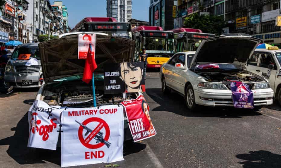 Taxis block a road, pretending to have broken down, during a protest against the coup on Monday.
