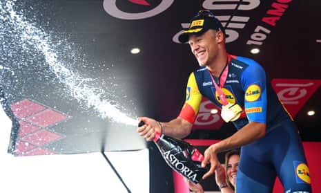 Jonathan Milan celebrates on the winner’s podium