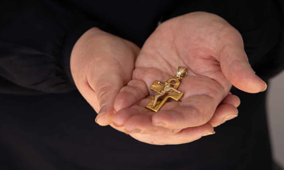 Najwa Rizk holds her husband’s crucifix