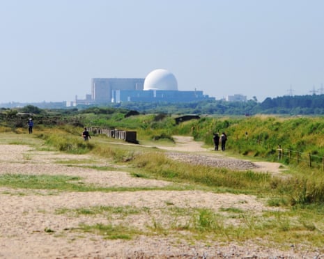 Walkers on a sandy path at Minsmere, with Sizewell B power station in the distance
