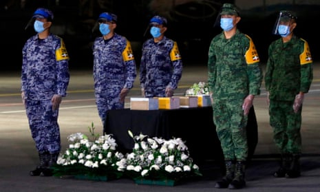 Mexican military personnel stand next to some of the more than 200 urns containing the repatriated ashes of those who died of Covid-19 in the US. Mexico now has the fourth-highest death toll.