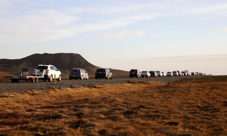 A line of cars queued on a road heading to the town of Grindavík, after residents were briefly allowed to return to their homes on Monday.