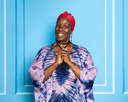 Portrait of Pauline Tomlin against a pale blue background