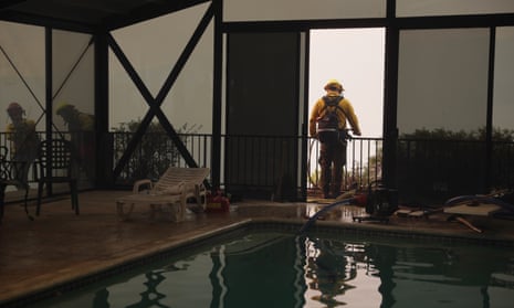 Firefighters deploy structure defense against the Palisades wildfire in Los Angeles, California, USA, 11 January 2025. Thousands of firefighting and emergency personnel are involved in response efforts, as multiple wildfires continue to burn across thousands of acres in Southern California, destroying thousands of homes and forcing people to evacuate areas throughout the Los Angeles area. EPA/ALLISON DINNER